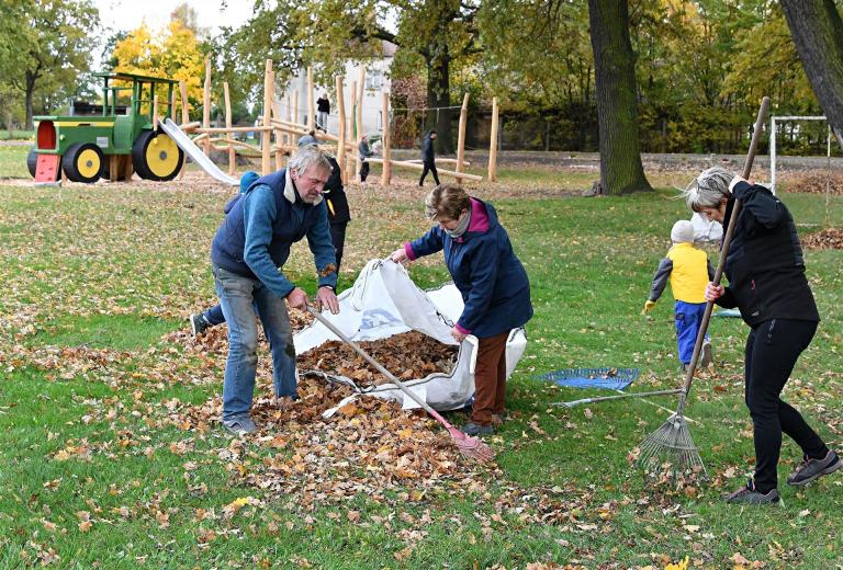 Laub harken zur Spielplatz-Einweihung